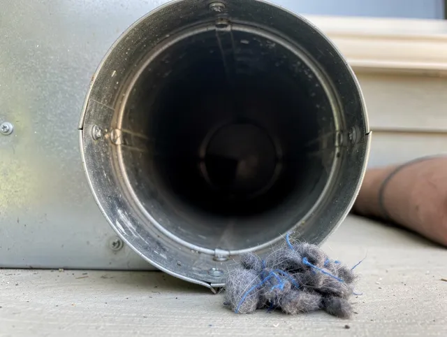 Barberton Dryer Vent Cleaning technician using specialized equipment to clear severe dryer vent blockage in Barberton